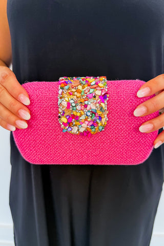 The Giada Bejeweled Straw Clutch in Fuchsia