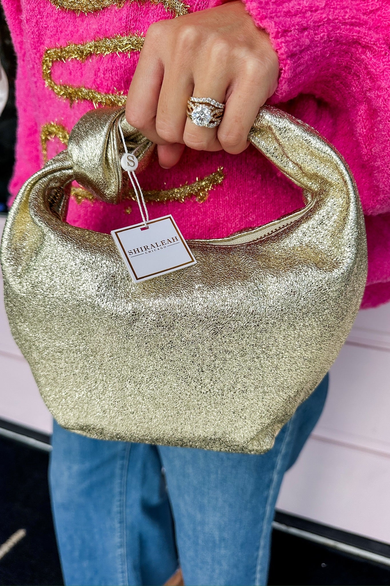 The Chrissy Knotted Top Handle Metallic Bag in Gold