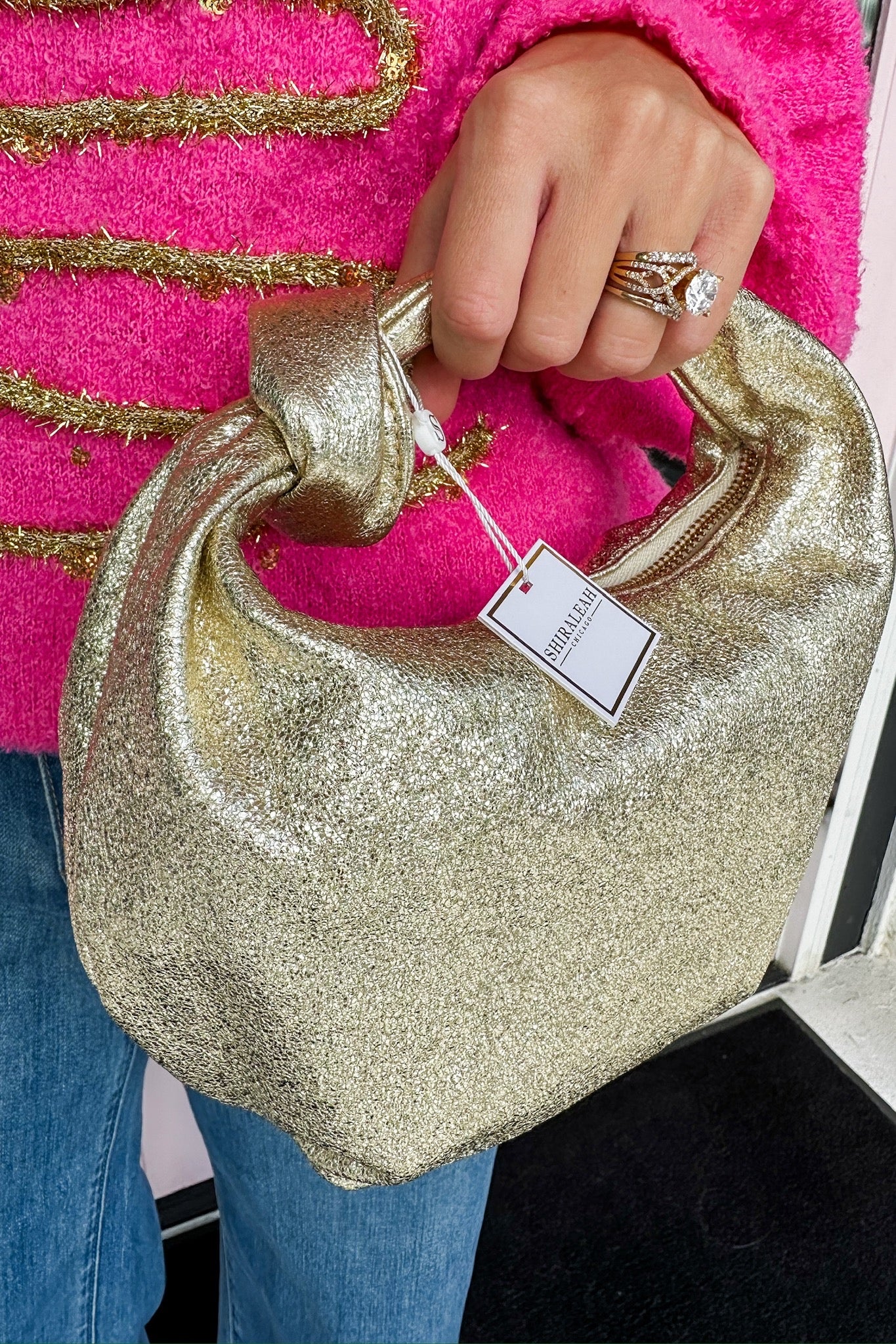 The Chrissy Knotted Top Handle Metallic Bag in Gold