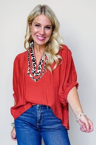 The Sarah Cheetah Print V Neck Top In Rust